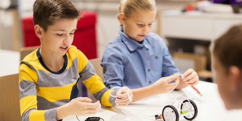 happy-children-building-robots-at-robotics-school.jpg